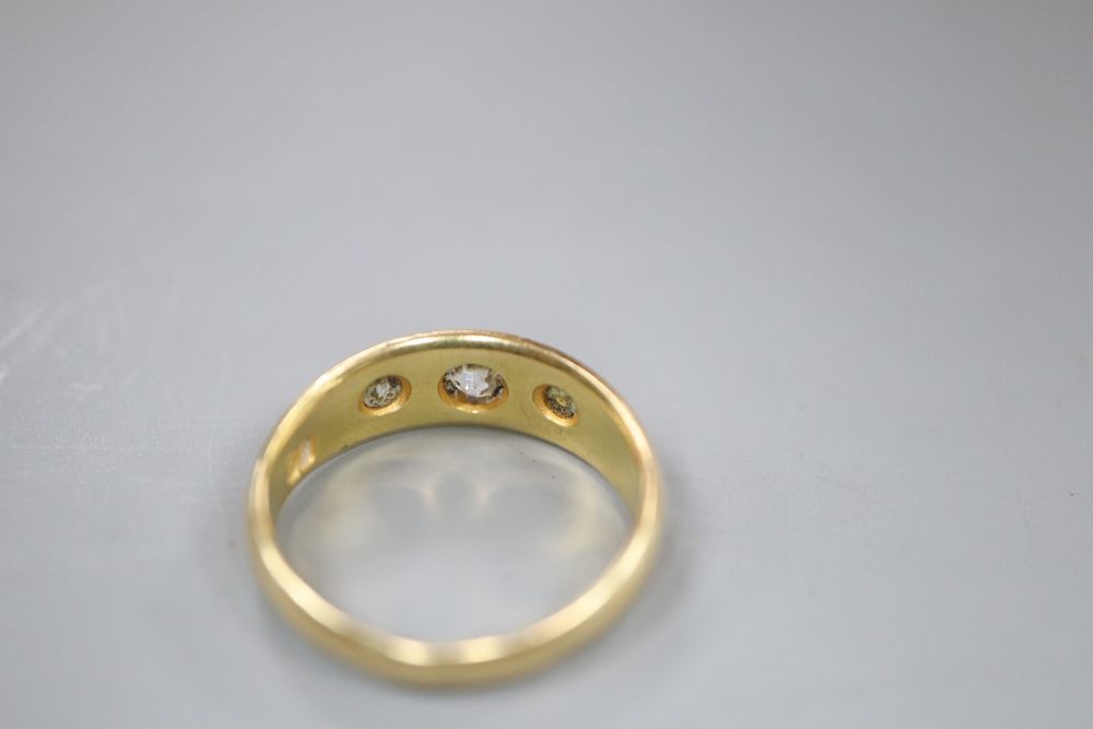A Victorian 18ct gold and gypsy set three stone diamond ring, size O, gross 5.7 grams.